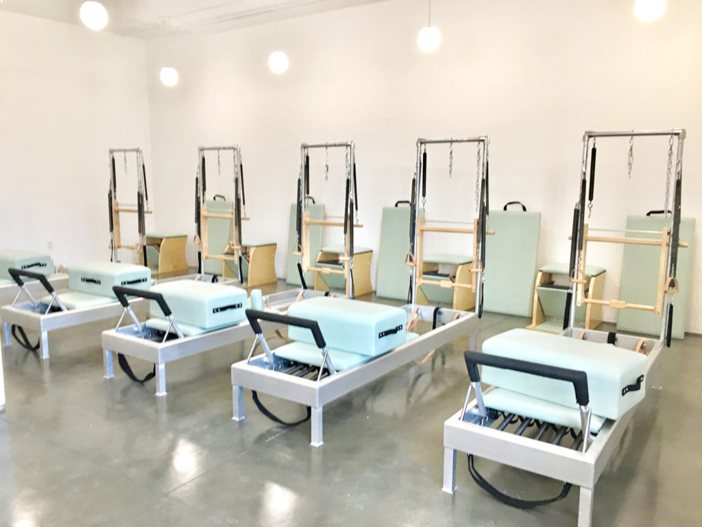 Bright and clean boutique Pilates studio equipped with Reformers, Towers and Pilates chairs